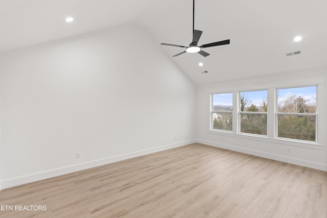 spare room with baseboards, visible vents, recessed lighting, vaulted ceiling, and light wood-type flooring