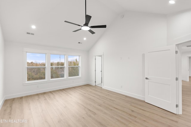 spare room with recessed lighting, light wood-style floors, baseboards, and high vaulted ceiling