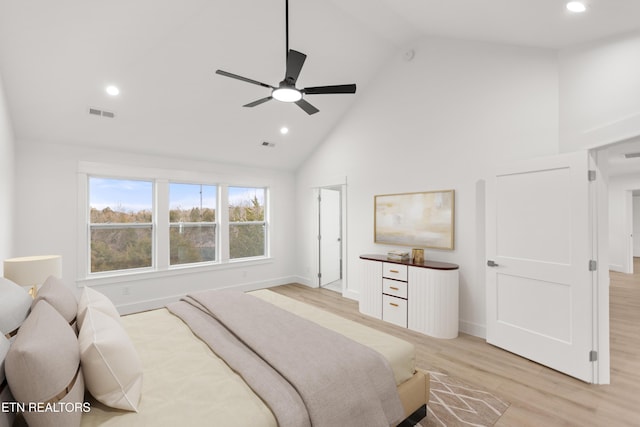 bedroom with recessed lighting, light wood-style floors, baseboards, and high vaulted ceiling