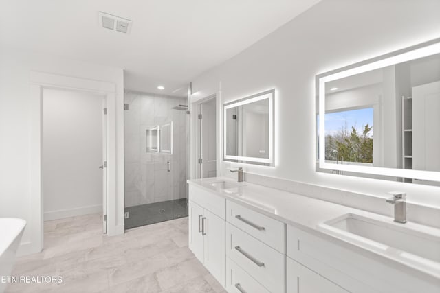 bathroom featuring double vanity, a stall shower, marble finish floor, and a sink