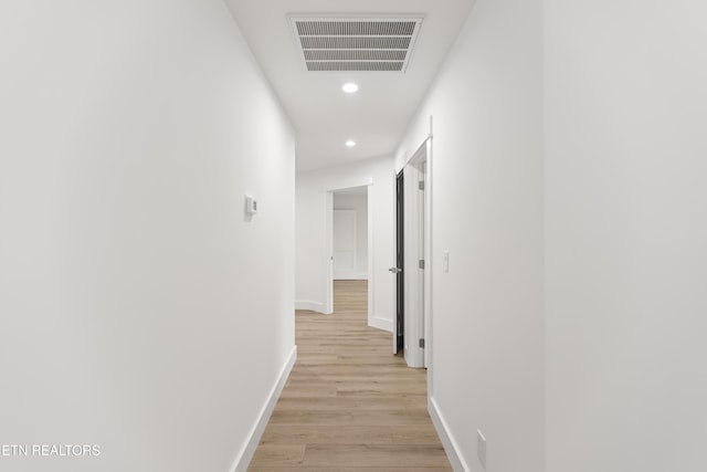 hallway with recessed lighting, visible vents, baseboards, and light wood-style floors