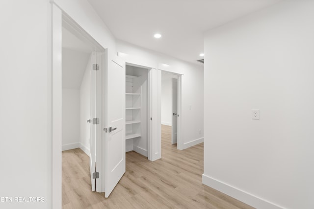 hallway with recessed lighting, baseboards, and light wood finished floors