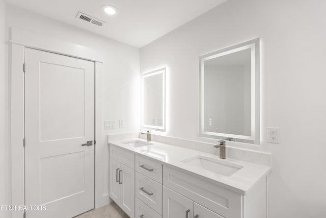 full bathroom with double vanity, recessed lighting, visible vents, and a sink