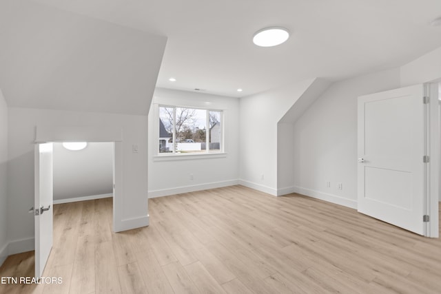 additional living space featuring recessed lighting, baseboards, vaulted ceiling, and light wood finished floors