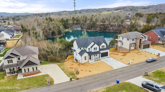 bird's eye view with a forest view, a water view, and a residential view