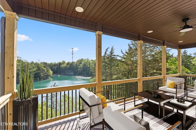 deck featuring a water view and a ceiling fan