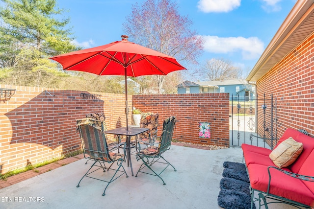 view of patio with outdoor dining area and fence