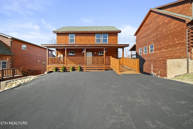 log home with a porch and log siding