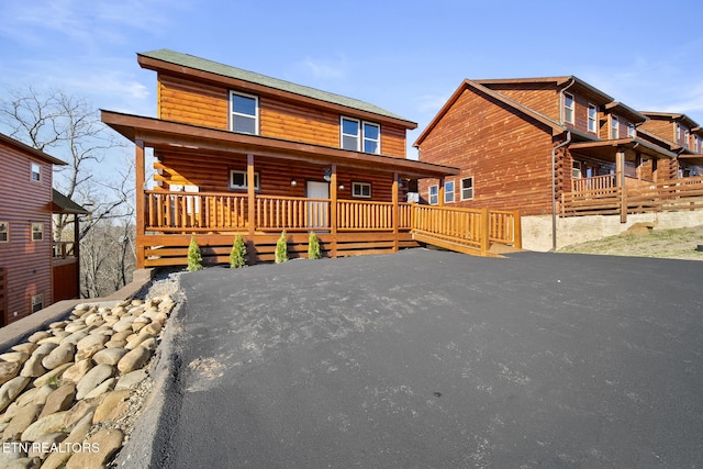 log home with covered porch and log exterior