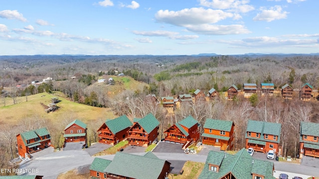 drone / aerial view featuring a forest view