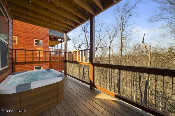 wooden deck with a hot tub