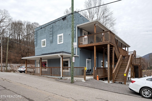 view of front of house with covered porch and stairs