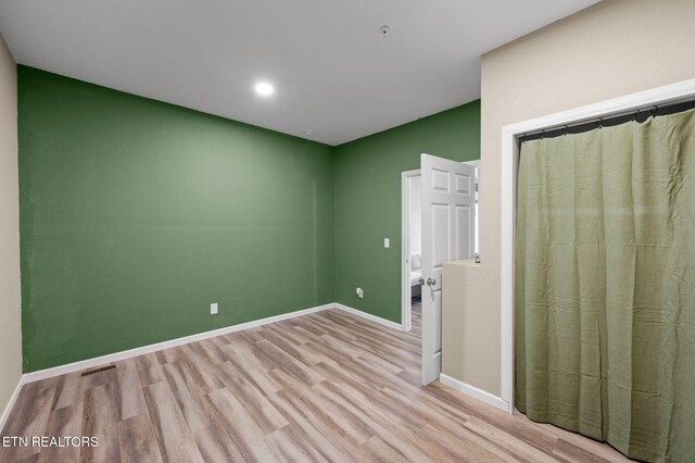 unfurnished room with visible vents, baseboards, and light wood-style flooring