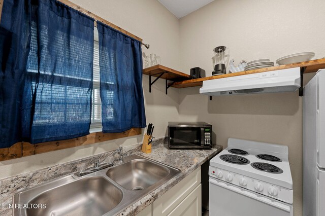 kitchen with a sink, open shelves, under cabinet range hood, white appliances, and white cabinets
