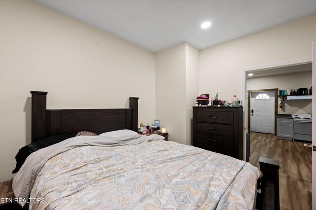 bedroom with recessed lighting and wood finished floors