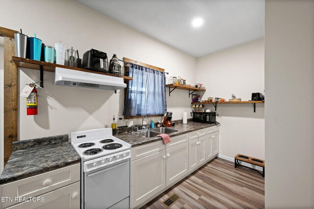kitchen featuring dark countertops, open shelves, under cabinet range hood, white electric stove, and a sink