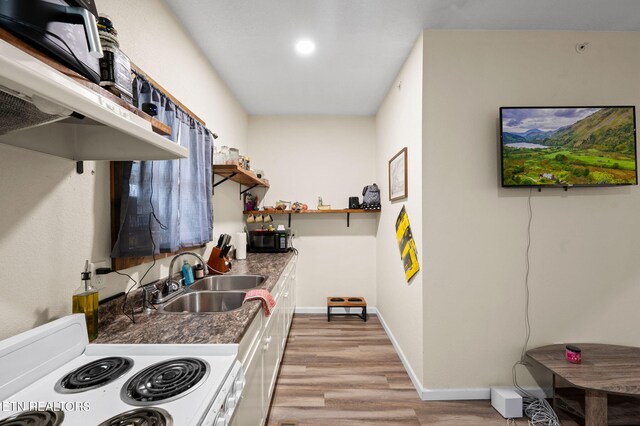 kitchen featuring a sink, open shelves, white electric range oven, light wood finished floors, and baseboards