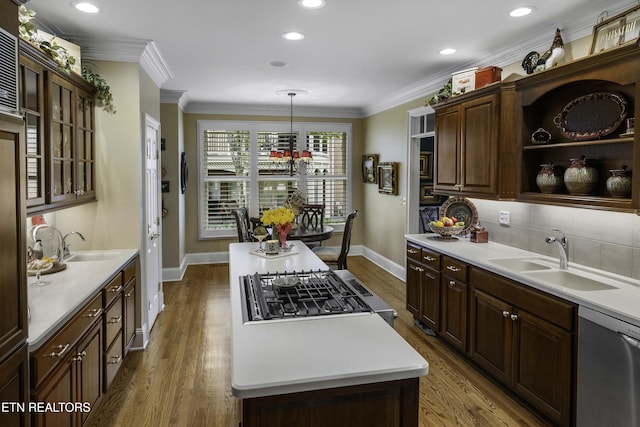 kitchen featuring ornamental molding, dishwasher, dark wood-type flooring, and a sink