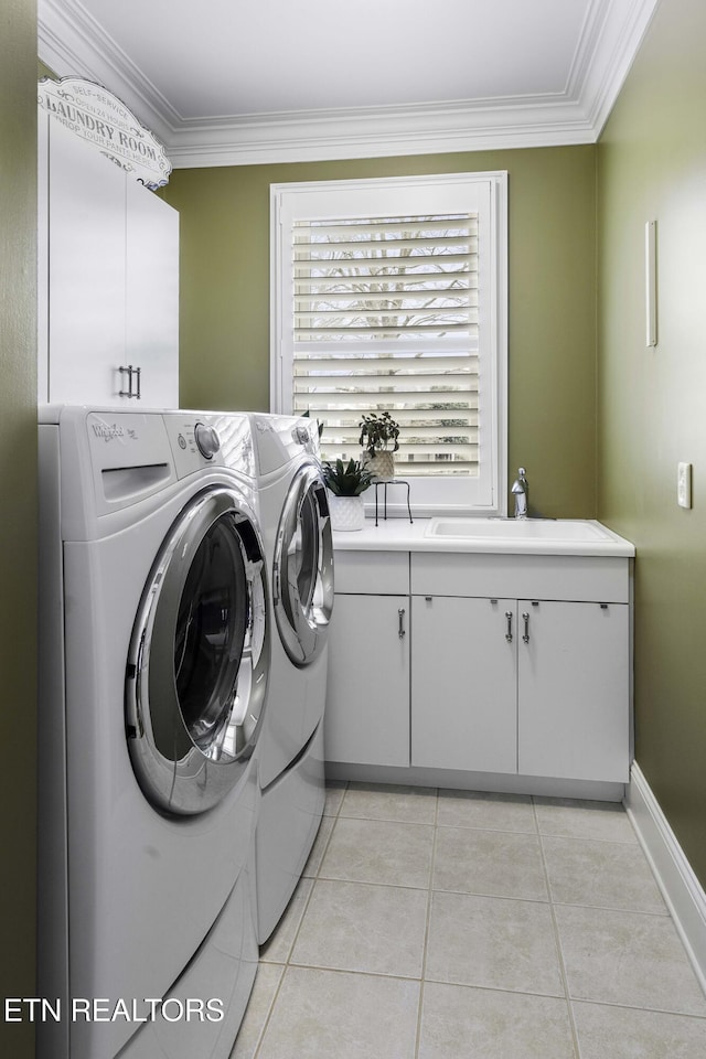 laundry room featuring a sink, cabinet space, separate washer and dryer, crown molding, and light tile patterned floors