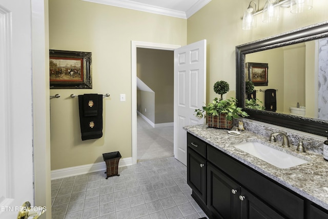 bathroom featuring vanity, toilet, baseboards, and ornamental molding