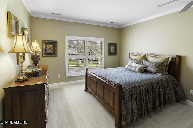 bedroom featuring visible vents, light colored carpet, baseboards, and ornamental molding