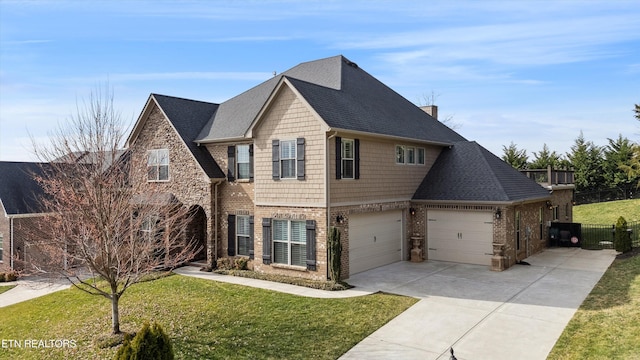 view of front of house featuring brick siding, a chimney, a shingled roof, a front yard, and driveway