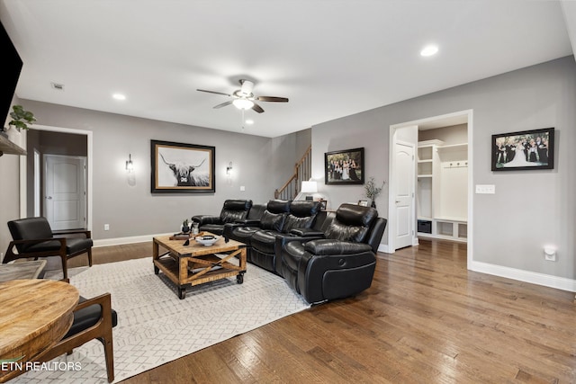 living area featuring recessed lighting, wood-type flooring, stairway, ceiling fan, and baseboards