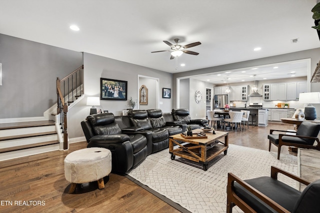 living area with stairway, wood finished floors, and recessed lighting