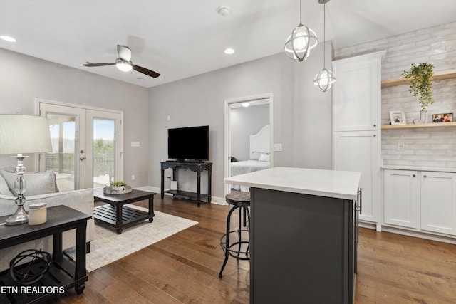 living room featuring baseboards, a ceiling fan, dark wood-style flooring, french doors, and recessed lighting