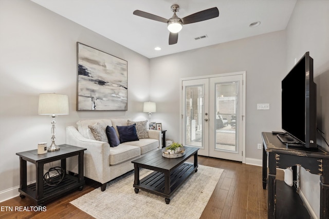 living area with french doors, visible vents, ceiling fan, baseboards, and hardwood / wood-style flooring