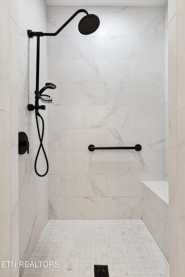 bathroom with tiled shower