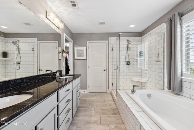 full bath featuring a stall shower, visible vents, and a sink