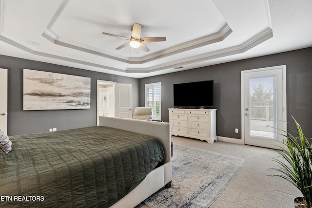 carpeted bedroom featuring ornamental molding, a tray ceiling, baseboards, and access to exterior