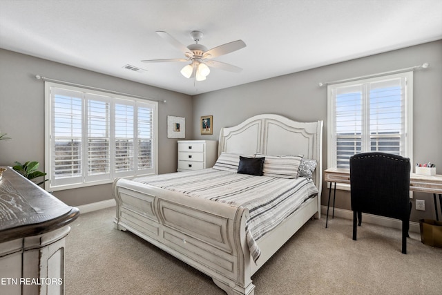 bedroom featuring baseboards, visible vents, carpet flooring, and multiple windows