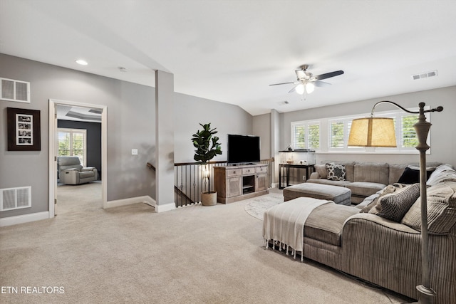 carpeted living area featuring visible vents and a wealth of natural light