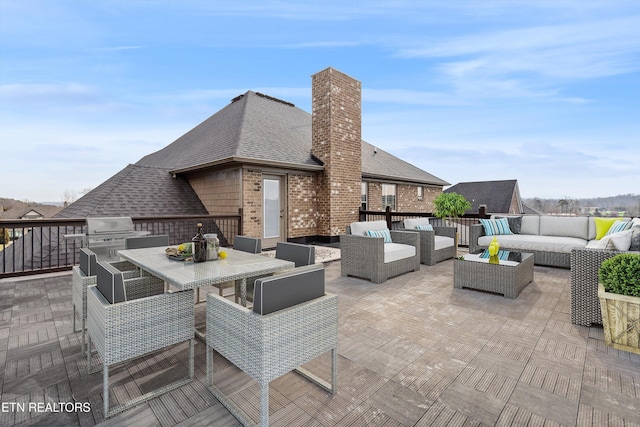 view of patio / terrace featuring grilling area, an outdoor living space, and outdoor dining space