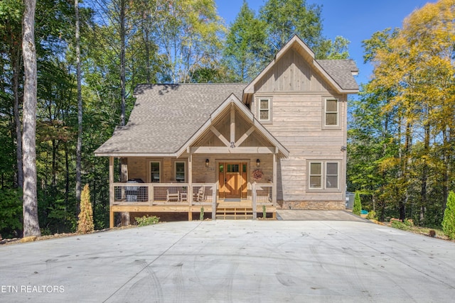 view of front of property featuring covered porch and roof with shingles