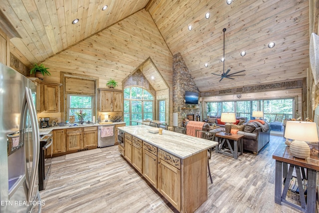 kitchen with stainless steel appliances, plenty of natural light, wood ceiling, and light wood-style floors