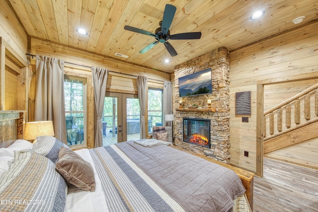 bedroom with wooden walls, wood ceiling, and access to exterior