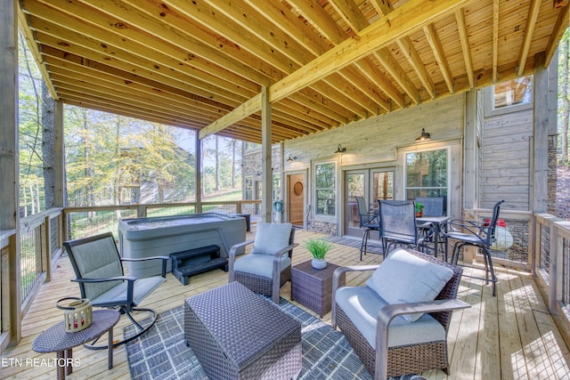 wooden terrace with a hot tub