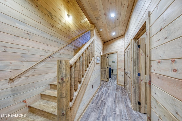 staircase featuring wood walls, wood finished floors, wood ceiling, and recessed lighting