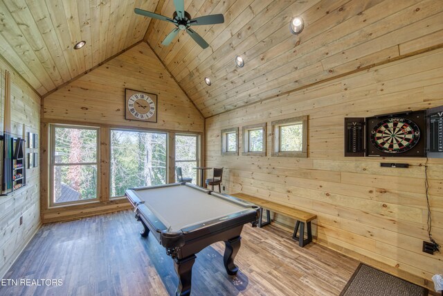 rec room featuring wooden walls, wood ceiling, wood finished floors, pool table, and high vaulted ceiling