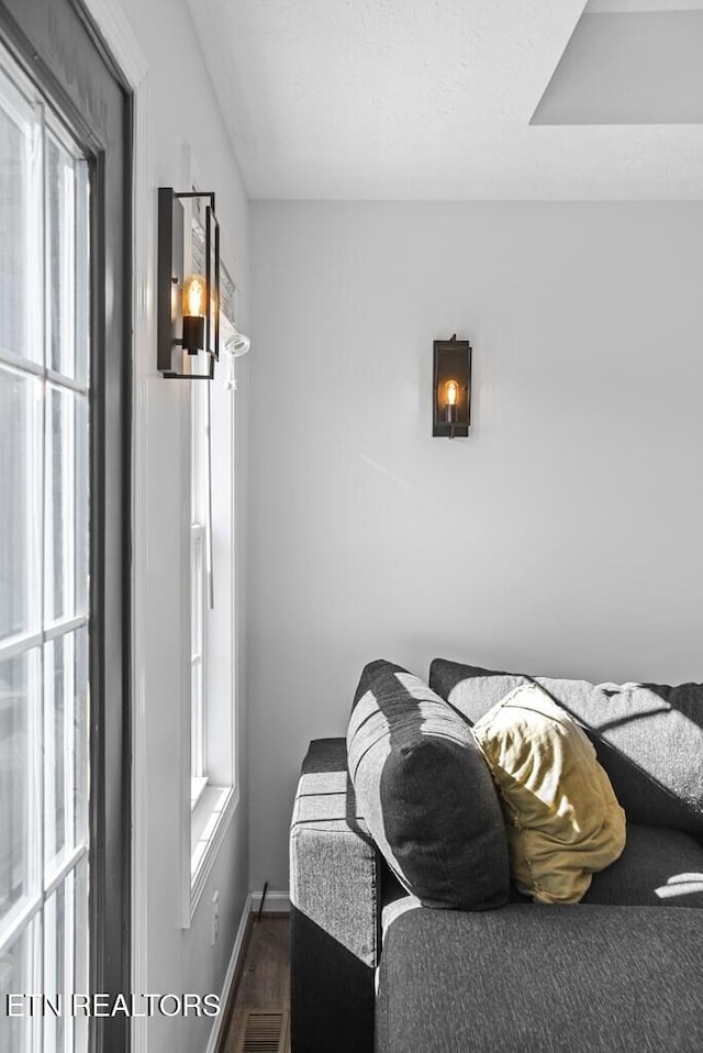 bedroom with dark wood-style flooring and baseboards