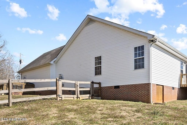 rear view of property with a lawn and fence