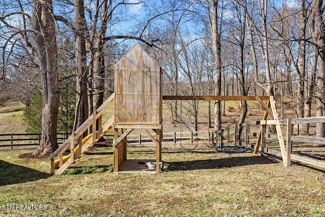 view of jungle gym featuring a yard and fence