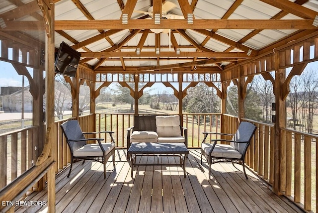 wooden terrace featuring an outdoor hangout area and a gazebo