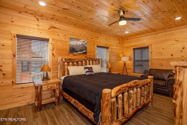 bedroom with recessed lighting, wooden ceiling, wooden walls, and wood finished floors