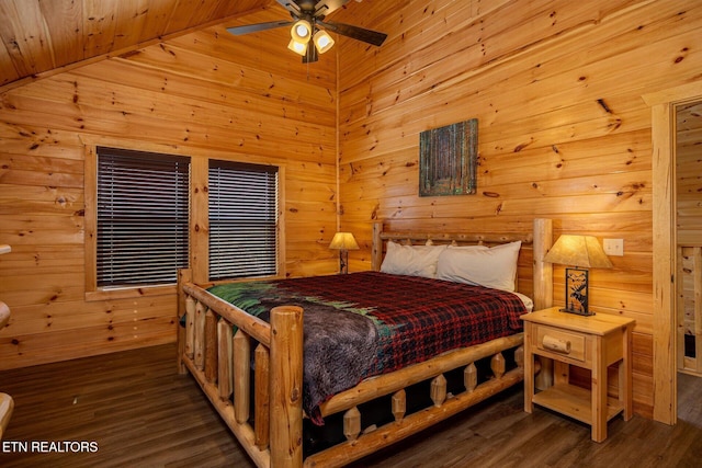 bedroom with wooden walls, vaulted ceiling, and wood finished floors