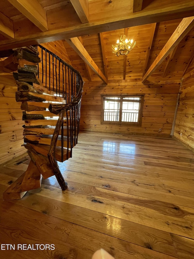 stairway featuring vaulted ceiling with beams, wooden walls, wood ceiling, hardwood / wood-style floors, and an inviting chandelier