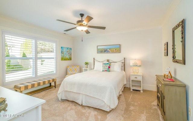 bedroom with a ceiling fan, light colored carpet, crown molding, and baseboards